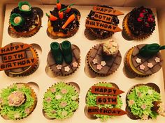 a box filled with cupcakes decorated to look like farm animals and carrots