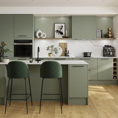 two green bar stools are in front of the kitchen counter