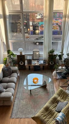 a living room filled with furniture and lots of windows next to a window sill