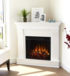 a living room with a fire place and pictures on the wall