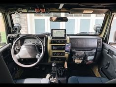 the interior of a vehicle with dashboard, steering wheel and other items on display in it