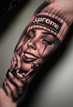 a woman's arm with the words supreme on it and an image of her face