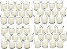 a bunch of glasses filled with milk on top of a white table next to each other