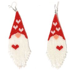 a pair of red and white beaded earrings with a gnome face on the side