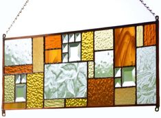 a stained glass panel hanging from a chain