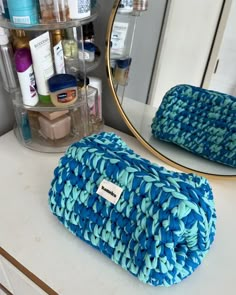 a blue towel sitting on top of a counter next to a mirror