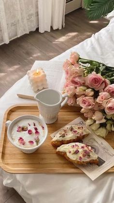 a tray that has some food on it and flowers in the bowl next to it