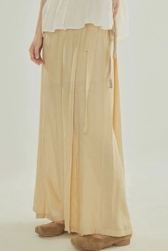 Inspired by Song Ku 宋裤 (Song Dynasty trousers), these wide legged pants are perfect for daily wear. Made of light and breezy fabric, these pants are lined within to ensure no flashes. Features the traditional waist tie but paired with a modern zipper closure. Triangular side pleats, creating the iconic flared shape. Wear as-is or under skirts! These fun pants can easily be styled with modern and traditional pieces. This item has a 7 day construction period. Materials: 82.6% viscose, 17.4% nylon Spring Daywear Wide Leg Harem Pants, Spring Wide Leg Harem Pants For Daywear, Solid Wide Leg Pants For Daywear, Beige Wide Leg Pants For Spring Daywear, Relaxed Fit Wide Leg Maxi Skirt For Daywear, Beige Wide Leg Full Length Pants For Spring, Spring Wide Leg Full Length Pants For Daywear, Summer Beige Wide Leg Daywear Pants, Beige Wide Leg Pants For Summer Daywear