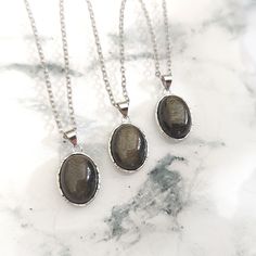 Beautiful Golden Sheen Obsidian Pendants on your choice of Chain or Waxed Cotton Cord, with a specially chosen Gemstone Tumble stone in a Gift Pouch. Obsidian is a Protective Gemstone which can be good for Calming emotions too. The Stainless Steel chain is hypoallergenic. The Silver is 925 Sterling Silver. The Dark Chain is nickel & lead free. The Cords are Waxed Cotton. You should always seek medical advice from your GP or Healthcare Professional if you are unwell. Crystals should never be used Silver Obsidian Gemstone Necklace, Obsidian Natural Stones Necklace For Gift, Gift Obsidian Necklaces With Natural Stones, Gift Obsidian Necklace With Natural Stones, Silver Obsidian Necklaces, Silver Obsidian Necklace With Natural Stones, Obsidian Gemstone Necklace For Gift, Silver Obsidian Jewelry For Healing, Golden Sheen Obsidian