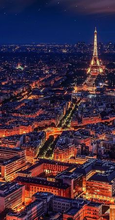 the eiffel tower lit up at night in paris, france as seen from above