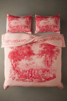 an image of a bed with red and white comforter set on top of it