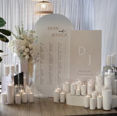 a table topped with lots of white candles