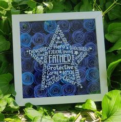 a frame with the word father written in different languages on it and surrounded by green leaves