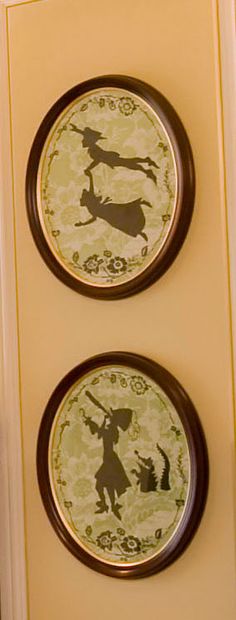 two plates with designs on them are hanging on the wall