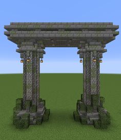 two stone pillars in the middle of a field