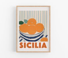 an oranges in a bowl with the word siclia on it is mounted to a wall