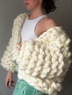 a woman wearing a white knitted shawl