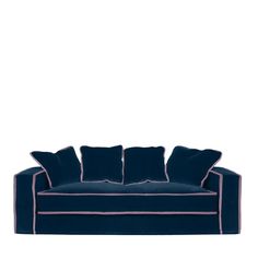 a blue couch with four pillows on it