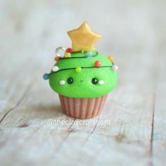 a green cupcake with a star on top