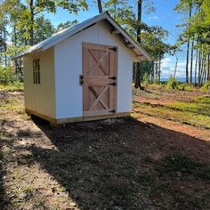 a small shed in the middle of a field