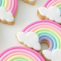 cookies decorated with rainbows and clouds on a table