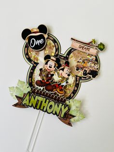 mickey and minnie mouse cake topper on a stick