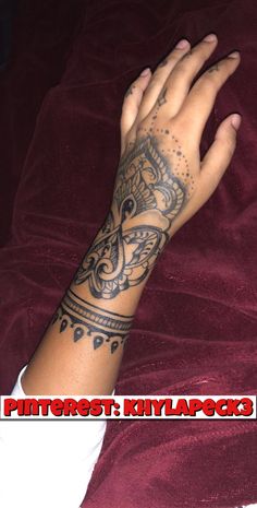 a woman's arm with a tattoo on it and her hand in the air