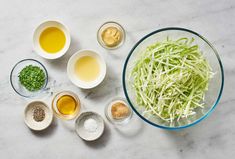 the ingredients for this dish include shredded cabbage, mustard, garlic and seasonings in small bowls