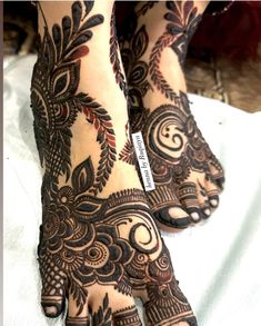 the feet are decorated with henna designs