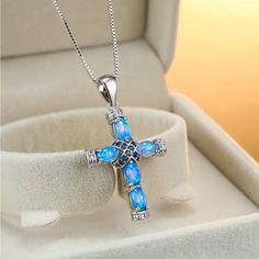 Beautiful Synthetic Blue Opal Cross With Sapphire Color Accent Stones Blue Spiritual Birthstone Jewelry, Spiritual Blue Cross Pendant Necklace, Blue Round Sterling Silver Jewelry, Royal Blue Pendant Jewelry As Gift, Royal Blue Pendant Jewelry For Gifts, Royal Blue Pendant Jewelry Gift, Blue Clavicle Chain Jewelry As Gift, Blue Cross Spiritual Necklace, Blue Clavicle Chain Jewelry For Gifts