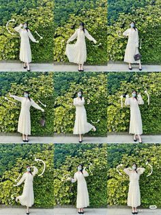 woman in white dress standing next to green hedges with arms outstretched and hands out