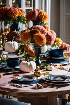 a table set for thanksgiving dinner with pumpkins and flowers