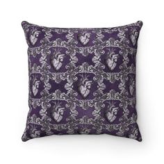 a purple pillow with an ornate design on it