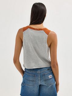 Discover your new go-to for every game in the Women’s Wrangler® Collegiate Vintage Muscle Tee. This vintage-inspired sleeveless muscle tank delivers the school spirit you want, with a distressed print of your team's logo, name, and founding date across the front. It’s crafted from a comfortable cotton blend, complete with a raw edge hem, a cropped length, and your team’s color at the shoulders. This graphic tank will quickly become your go-to for game day. Sporty Tank Top For College In Summer, Cotton Tank Top For College In Summer, Sporty Summer Tank Top For College, Casual Summer Tank Top For College, Sporty Cotton Tank Top For College, Casual Cotton Racerback Tank Top, Casual Sleeveless Tank Top For College, Sporty Cotton Muscle Tee For Spring, Casual Racerback Tank Top For Streetwear