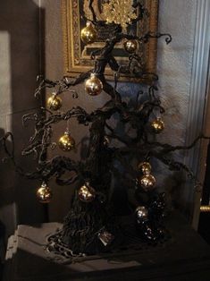 a black and gold christmas tree with ornaments