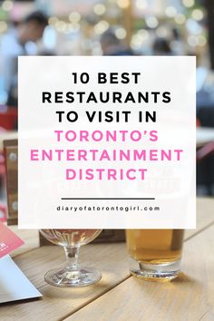 a glass of beer sitting on top of a wooden table with the words 10 best restaurants to visit in toronto's entertainment district