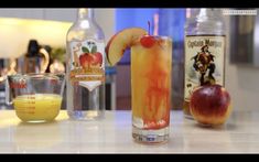 an apple and orange drink sitting on top of a counter