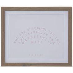 a white framed print with words written in pink on the bottom and below it is a wooden frame