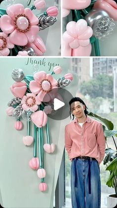 a woman standing next to a bunch of balloons in the shape of flowers and hearts