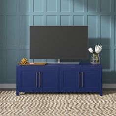 a blue entertainment center with a flat screen tv on it's stand in front of a wall