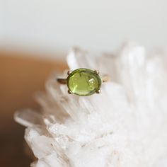 This gorgeous solid gold and Peridot ring has everything you want in a 14 KT Gold Peridot Statement Ring. Gorgeous, smooth Green Peridot cabochon - 8 CT - highlighted and set in 14KT GOLD setting - made to order. Choose your size in the listing. We wanted to show off this gorgeous Peridot Stone in a strong, solid gold prong setting with half-round prongs mimicking the soft cut of this gorgeous, natural Peridot stone. You will love the classic, translucent grass-green peridot in gold. This lovely Peridot Ring Gold, Silversmith Rings, 11 Stone, Kyanite Earrings, Jasper Ring, Tourmaline Earrings, Peridot Stone, Boho Pendant, Peridot Ring