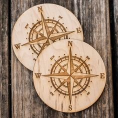 two wooden coasters with compass designs on them