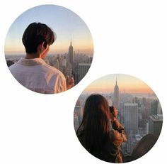 two people are looking at the city skyline