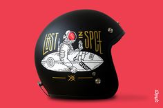 a black helmet with an image of a man riding a rocket ship on it's side