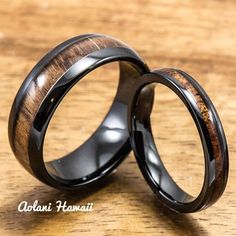 two black ceramic rings with wooden inlays