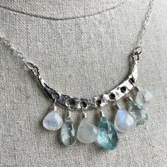 An heirloom piece. The artisan work on this solid sterling silver piece is just gorgeous. The aquamarines and rainbow moonstone used are very generously sized. The stones are wired in sterling silver to sterling silver chain with a 4" extender with pearl on the end. This necklace can be adjusted from 16" to 20". There is just one exactly like this available, so if you love it, don't wait! I will try to add more necklaces like this as I acquire the materials if you miss this one. Your necklace wi Fusion Style Silver Jewelry With Blue Topaz, Silver Briolette Blue Topaz Jewelry, Silver Blue Topaz Briolette Jewelry, Bohemian Silver Briolette Necklaces, Silver Moonstone Fusion Jewelry, Silver Fusion Moonstone Jewelry, Handmade Silver Aquamarine Necklace, Bohemian Sterling Silver Briolette Jewelry, Artisan Moonstone Jewelry One Of A Kind