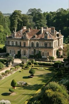 a large house with lots of trees in front of it