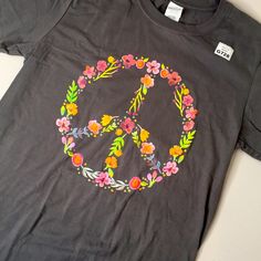 Flowers In A Peace Sign Soft Grey T-Shirt 100% Cotton Bust Approx 34” Stretches Make Me An Offer I’m Negotiable Peace Sign Shirt, Spring Hippie T-shirt With Screen Print, Cheap Hippie T-shirt With Retro Print, Cheap Cotton Groovy T-shirt, Cotton Peace Sign Short Sleeve T-shirt, Flower Tops, Cute Tshirts, Gray Tshirt, Peace Sign