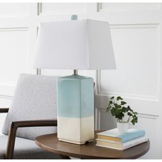 a table with a lamp and some books on it