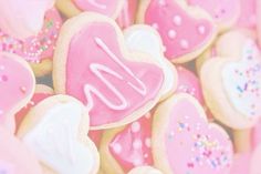 pink and white cookies with icing in the shape of hearts